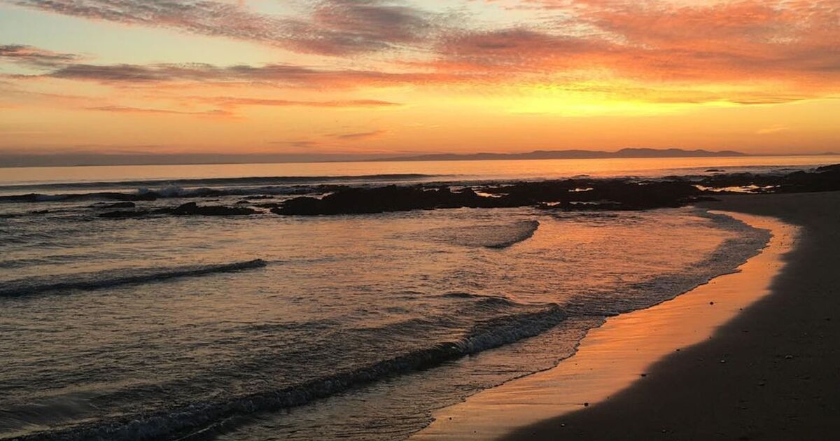 Little known stunning UK beach with miles of bright pink sand