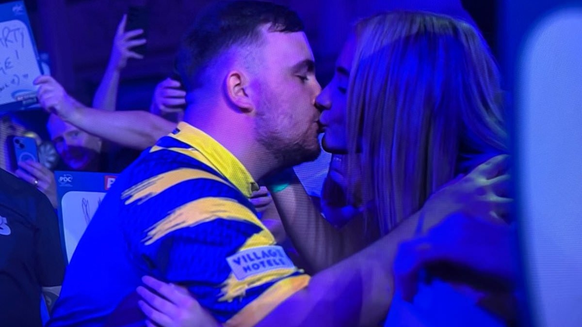 More than 'just friends'! Luke Littler kisses fun-loving beautician girlfriend in darts crowd - months after emphatically denying they were dating