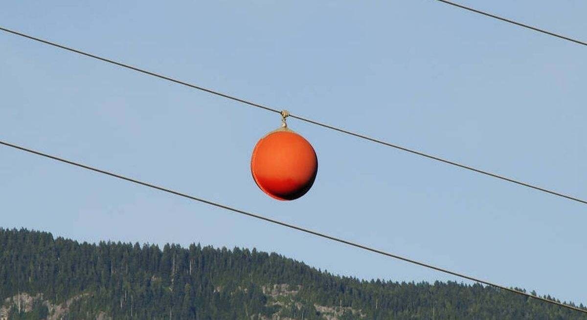 O que são as bolas laranjas nas linhas de energia e por que elas são tão importantes?